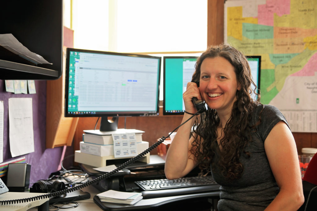 Eureka staffer smiling while answering the phone.
