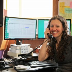 Eureka staffer smiling while answering the phone.